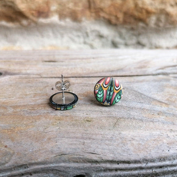 Pair of colorful earrings on a wooden surface