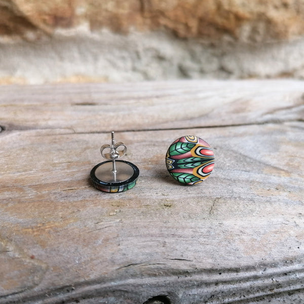 Colorful marbled earring on a wooden surface