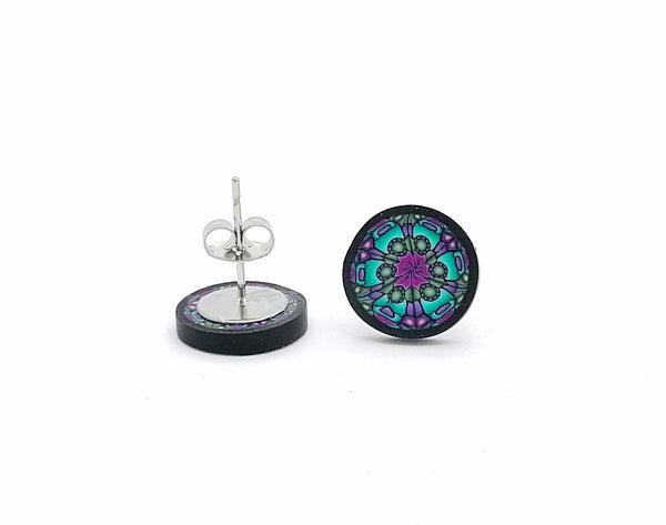 Round earrings with a colorful mandala design on a white background