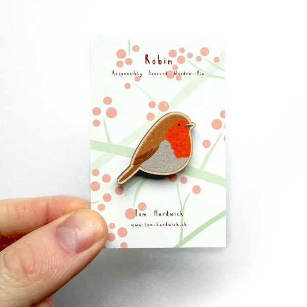 Bird-shaped pin held over a card with 'Robin' branding