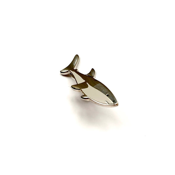 Metallic shark-shaped object on a white background