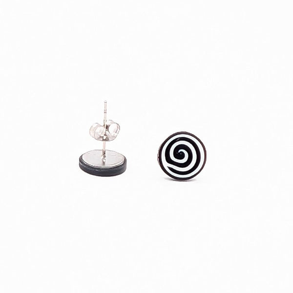 Pair of black and white spiral stud earrings on a white background