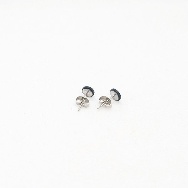 Pair of silver stud earrings on a white background
