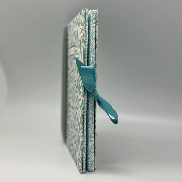Patterned notebook with a blue ribbon on a gray background