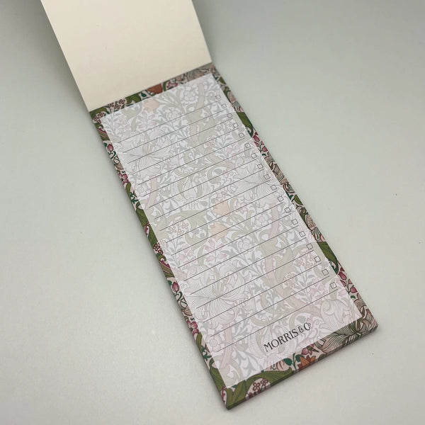 Floral patterned notepad with a pen holder on a light gray background