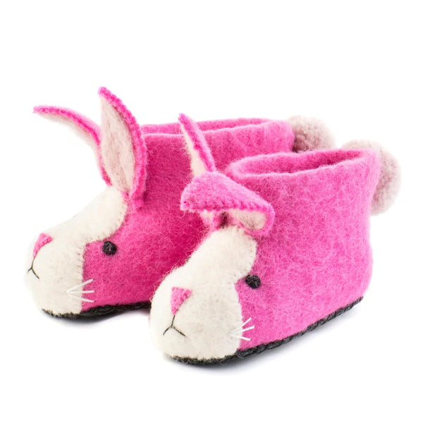 A side view of a pair of pink rabbit felted slippers by Heart So Felt in a children's size